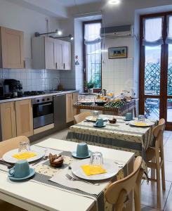 a kitchen with a table and chairs and a kitchen with at B&B Ponte Manin in Verona