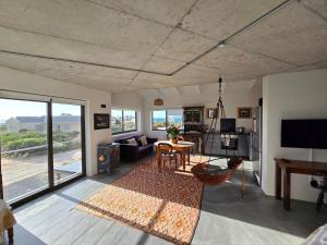 a living room with a couch and a table at Suikerbos in Pringle in Pringle Bay