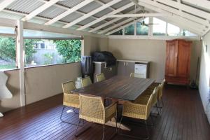 a dining room with a table and chairs at Beachside Chateau West Busselton in Busselton