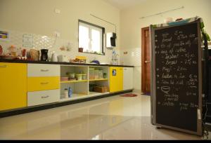 a kitchen with a black refrigerator with writing on it at White Camel companies in Hyderabad