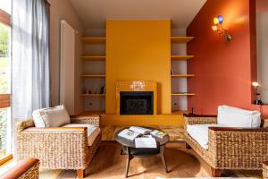 uma sala de estar com duas cadeiras e uma lareira em Al Castagneto Foresteria Lombarda em Montevecchia
