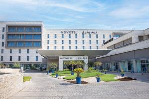 a large white building with the words novo hotel at Novotel Muscat Airport in Muscat
