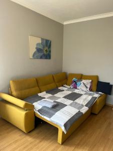 a bed in a room with a couch at Rio Sunny 2BDR Apt near NDK - Metro - non-stop paid public Parking in Sofia
