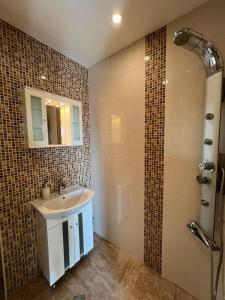 a bathroom with a sink and a shower at Rio Sunny 2BDR Apt near NDK - Metro - non-stop paid public Parking in Sofia