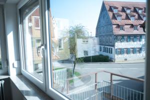 a window with a view of a street and buildings at Monteuerunterkunft - Flexibel und Modern!- NEU in Laichingen