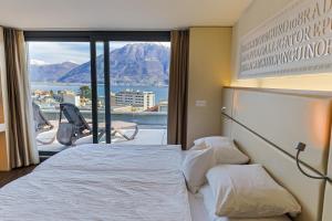 Rúm í herbergi á Hotel Muralto Locarno