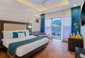 a bedroom with a bed and a living room at Zone Connect by The Park Mussoorie in Mussoorie