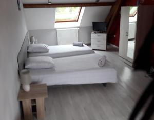 a room with two beds and a television in it at claude et chantal in Saint-Yorre