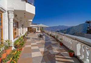 a building with a checkered floor and a balcony with plants at Zone Connect by The Park Mussoorie in Mussoorie