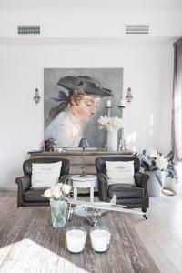 a living room with a couch and a painting at Royal penthouse, comfort and luxury in Cannes