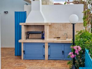 a kitchen with blue doors and a sink at Villa Marina in Ayia Thekla with Heated Pool in Ayia Napa +26 photos
