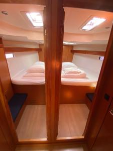 a small room with two bunk beds in it at Bavaria 45 Cruiser Prive huur incl. schipperservice in Sukošan