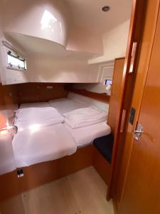a small cabin on a boat with two beds at Bavaria 45 Cruiser Prive huur incl. schipperservice in Sukošan