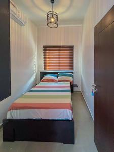 a bedroom with two beds and a window at Property House in Lomé