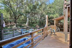 a wooden deck with a hot tub and chairs on it at 3065 Hideaway 8 Min Drive to Beach Hot Tub in Southern Shores