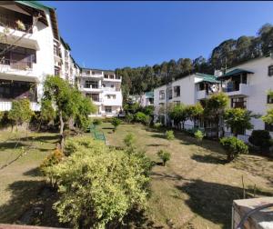 an empty yard in a city with buildings at Nainital Homes in Bhowāli
