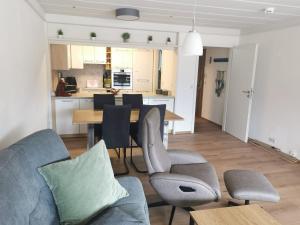 a living room and kitchen with a table and chairs at Fewo Alpenblick | Pool | Bergblick in Berchtesgaden
