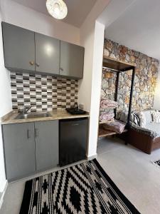 a kitchen with a sink and a counter top at Elenis Studios&Apartments in Masouri
