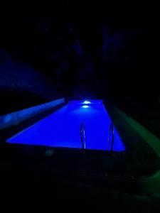 a dark room with a blue light in the dark at DOM V CHIMGANE in Kyzyldzhar
