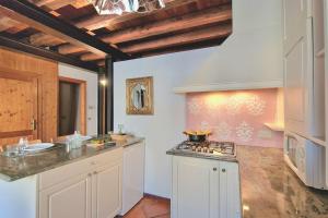 a kitchen with white cabinets and a stove top oven at Ca'Dinora - Caesar apartment in Bardolino +86 photos