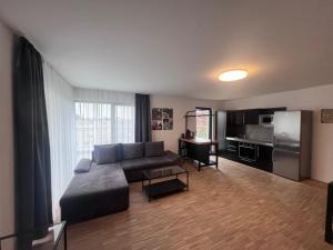 a living room with a couch and a kitchen at New Age Boardinghaus P5 in Heilbronn