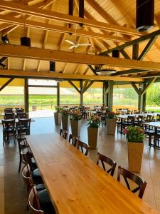 een grote eetkamer met tafels en stoelen bij BÉNI family wine farm in Cegléd