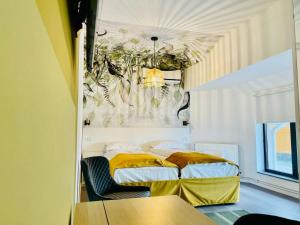 a room with two beds in it with a ceiling at Motel Azur in Calnic