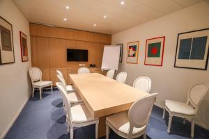 une salle de conférence avec une table et des chaises dans l'établissement Hotel Garni Muralto, à Locarno