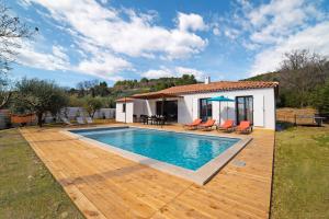a villa with a swimming pool and a house at Villa Ticka - Comfy villa avec piscine chauffée in Callas