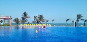 two children playing in the water at a resort pool at BORACAY VILLA B1007 in Long Hai