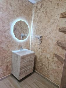 a bathroom with a sink and a mirror at complex turistic N&S in 2 Mai