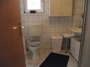 Un baño pequeño con inodoro y lavabo. en Ferienwohnung Annabelle, 15134, en Leer 28 fotos más