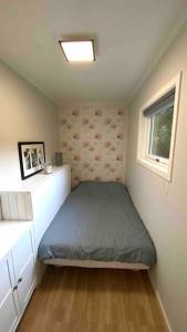 a small bedroom with a bed and a window at Green Forest Oasis & Sea in Strömstad