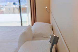 Rúm í herbergi á Hotel Muralto Locarno