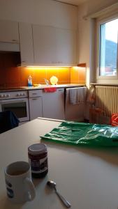 a kitchen counter with a cup of coffee and a spoon at Castle-View Bellinzona in Bellinzona