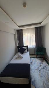 a bedroom with a large bed and a window at Luu Hotel in Corlu
