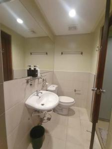 a bathroom with a sink and a toilet at Spacious Studio Apartment B502 in Manila