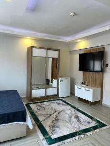 a bedroom with a bed and a flat screen tv at Luu Hotel in Çorlu