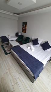 a bedroom with a large bed with blue sheets at Luu Hotel in Çorlu