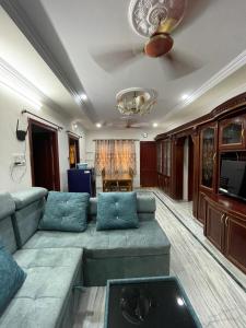 ein Wohnzimmer mit einem Sofa und einem Deckenventilator in der Unterkunft 5 Fully Furnished 2 BHK Flats in MVP Colony, Vizag in Visakhapatnam
