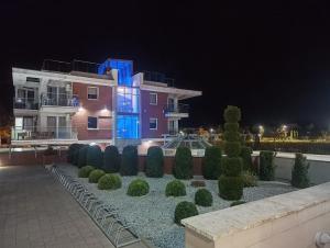 a building with a blue light on it at night at GOLD CLIFF APARTMENT NIECHORZE Baltic Cliff in Niechorze