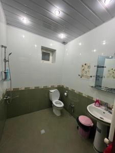 a bathroom with a toilet and a sink at Eden Guest House in Corat