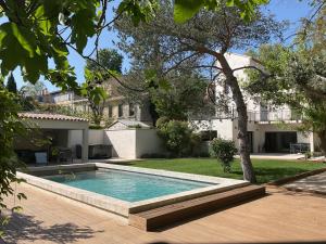 a swimming pool in the yard of a house at La Maison de l'Olivier in Avignon