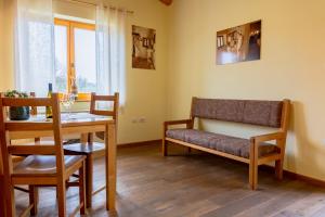 a living room with a bench and a table at Farm stay Šibav B&B in Dobrovo