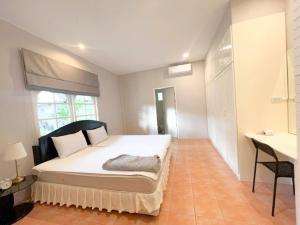 a bedroom with a bed and a desk in it at Prime Hill , Kathu Phuket / C2 in Ban Ket Ho