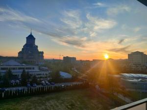 a sunset view of a city with a building at Parc Central Republicii 63 in Baia Mare