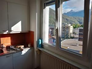 a kitchen window with a view of a mountain at Castle-View Bellinzona in Bellinzona