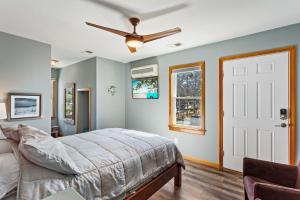 a bedroom with a bed and a ceiling fan at 2067 Duck Days Soundfront w Pier in Duck