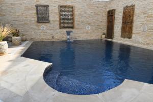 a large swimming pool in a brick building at Dar Al Makam - Luxury Experience in Soliman