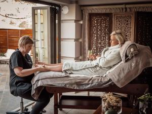 a woman getting a leg massage on a bed at Fairview Hotels,Spa & Golf Resort in Tzaneen